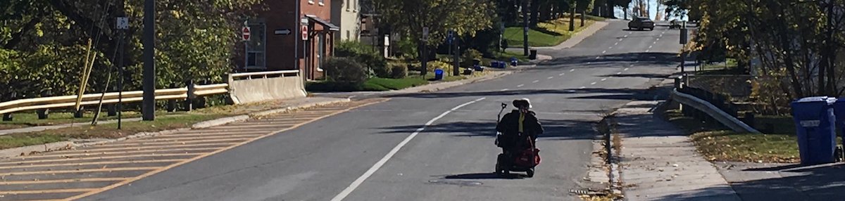 Person on Mobility scooter in the centre of the road