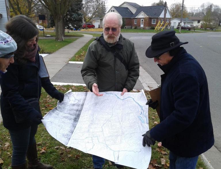 Peterborough. Residents pour over map during exploratory walk