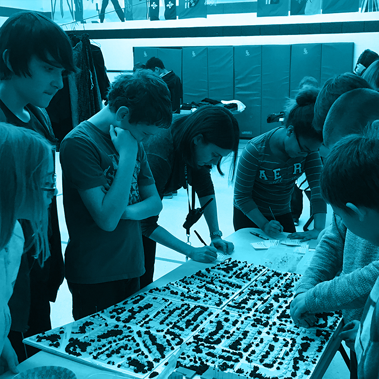 Image of seven youth engaging with a 3-D neighbourhood model